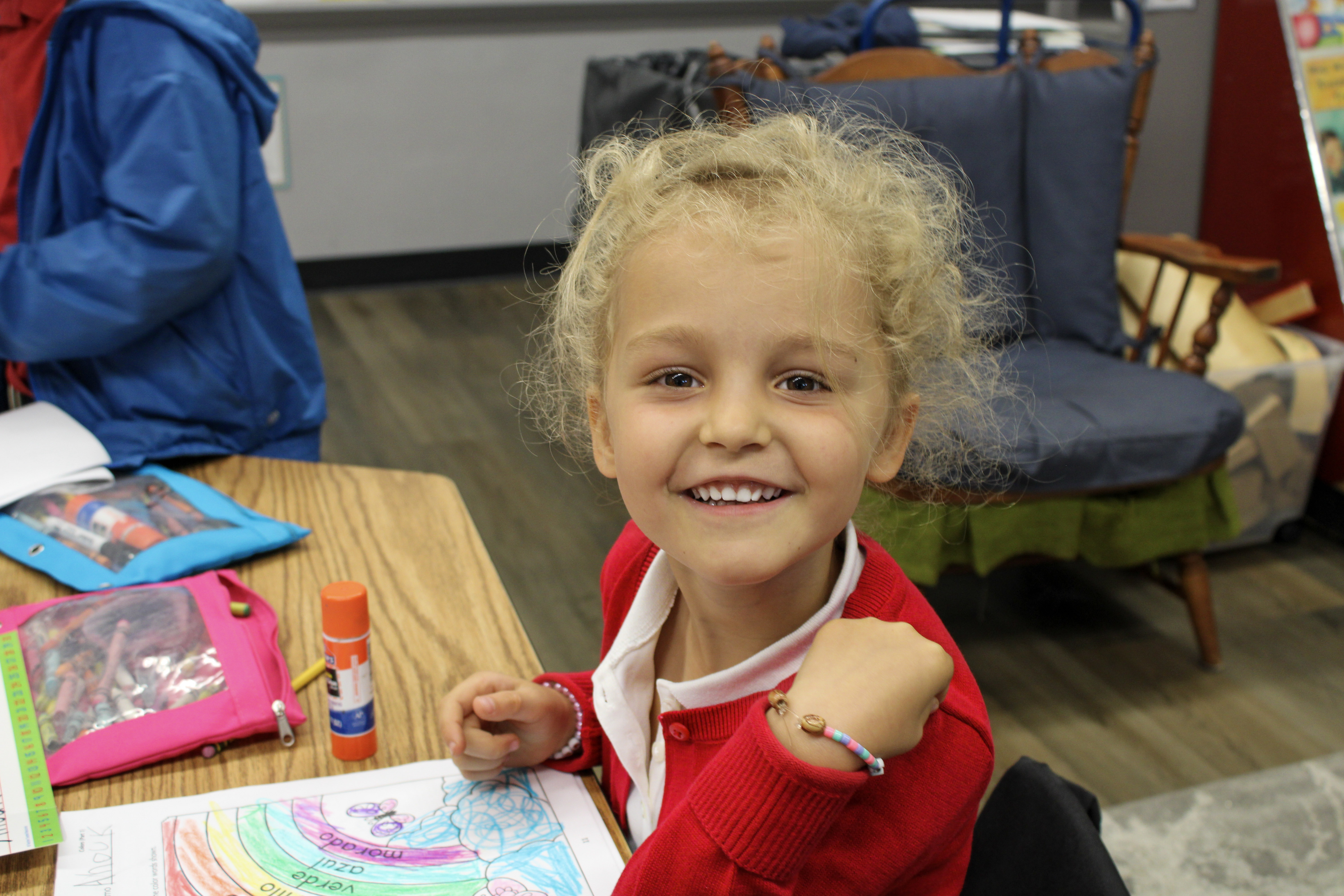 Young student coloring with crayons