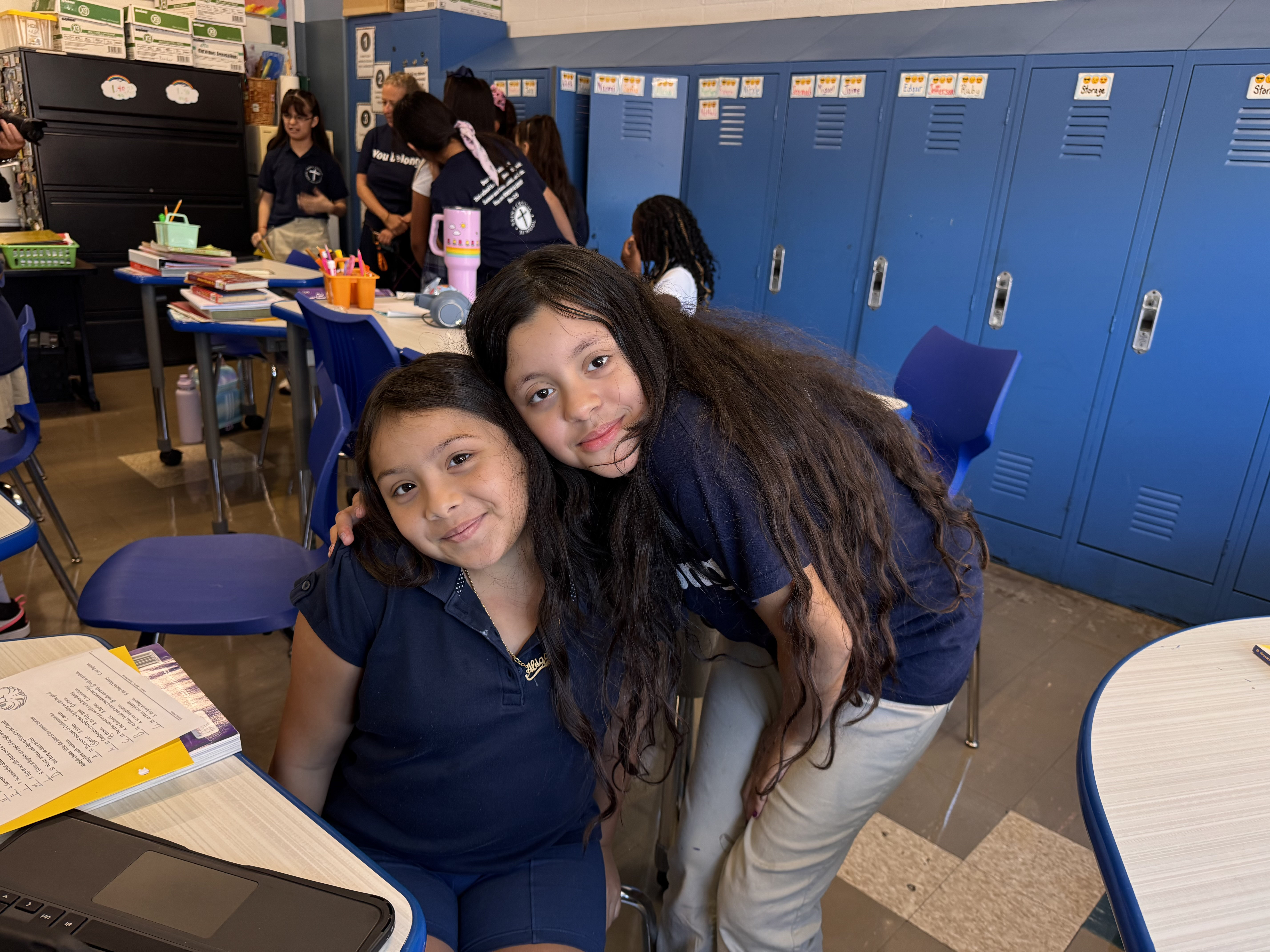 Two students embracing and smiling