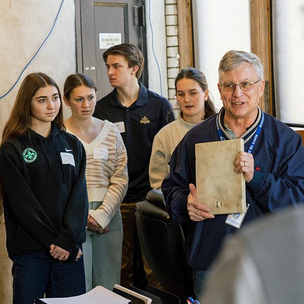 Students meeting and learning about relics and sacred items in the reclamation center