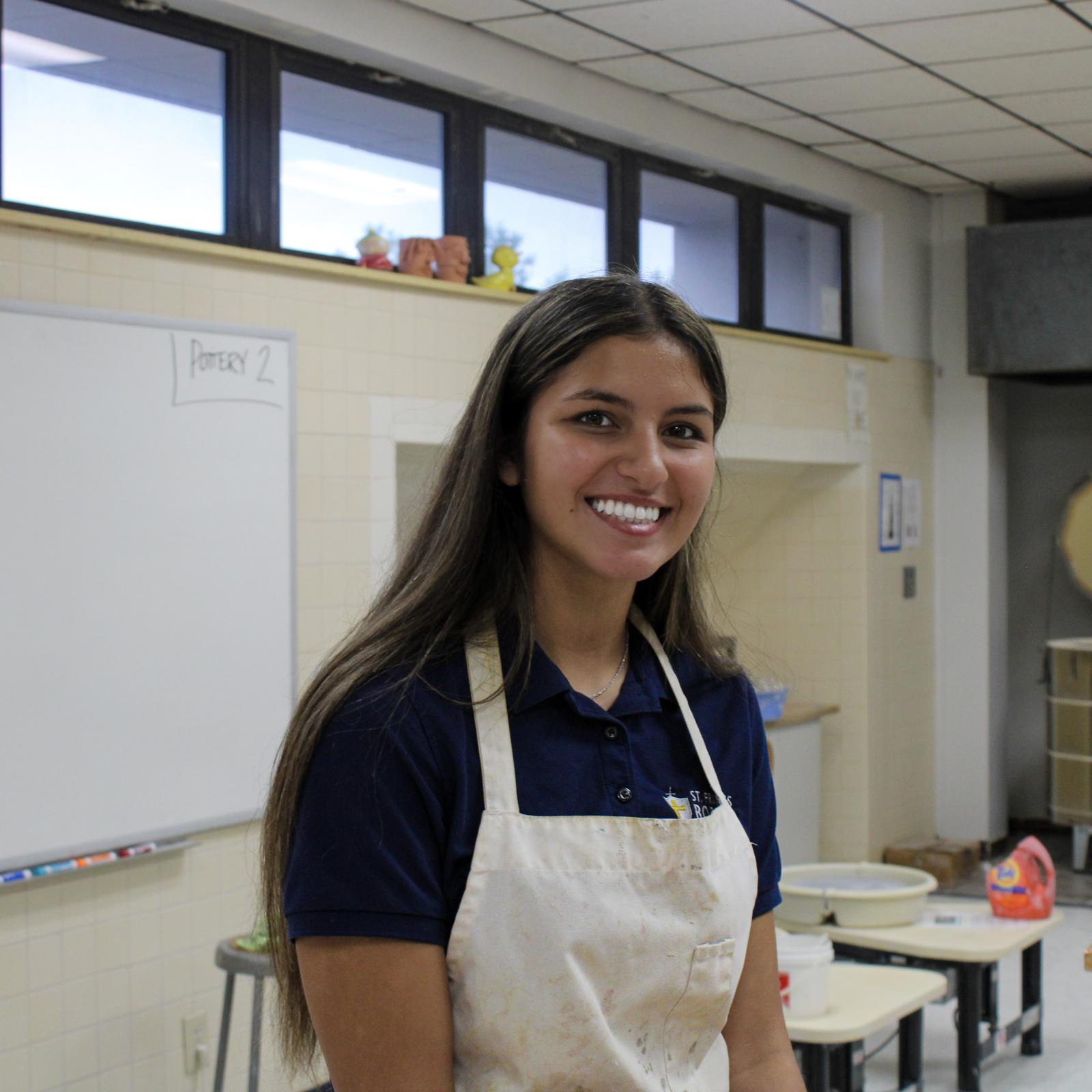 High school student wearing a lab apron