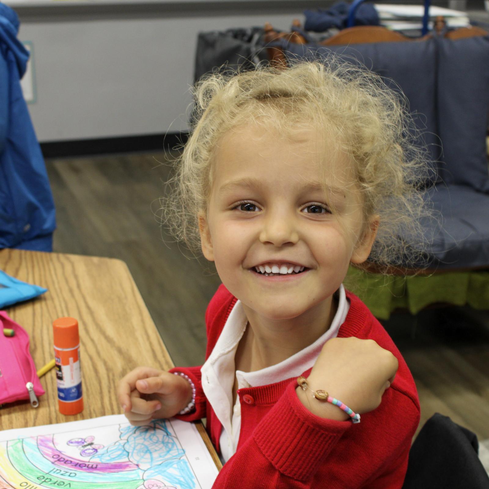 Young student coloring with crayons