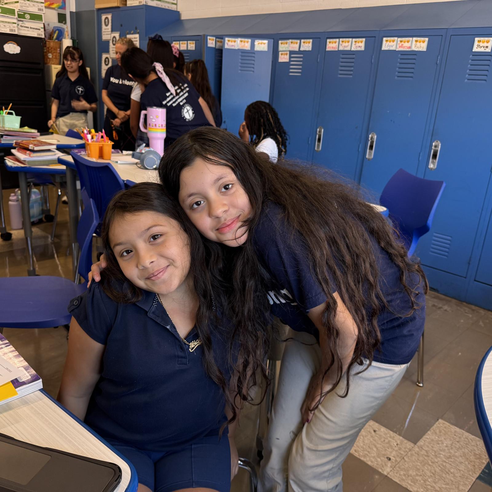 Two students embracing and smiling